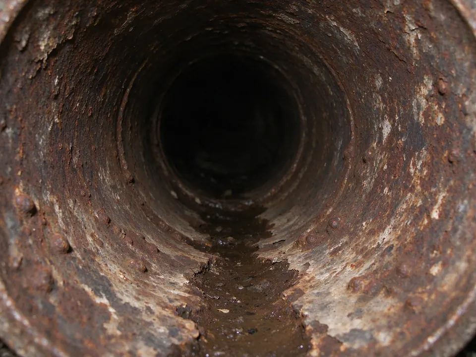 Sewer camera view of rust scale inside an old cast iron drain pipe