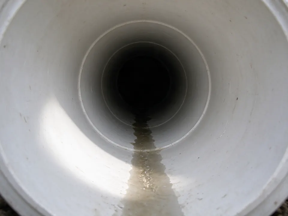 Sewer camera view inside a new smooth white PVC sewer pipe after replacement